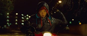 Movie still from “Attack the Block” (2011), directed by Joe Cornish – A man riding a motorcycle at night on the street; Medium shot, Low angle
