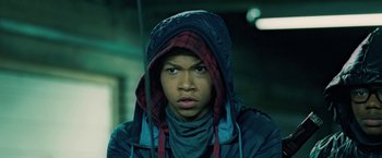 Movie still from “Attack the Block” (2011), directed by Joe Cornish – A young man with a hooded jacket and a scarf on; Close Up shot, Low angle