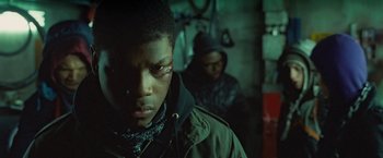 Movie still from “Attack the Block” (2011), directed by Joe Cornish – A man with a bandage on his face and a man with a bandage on his face; Close Up shot, Over the shoulder angle