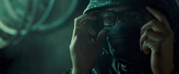 Movie still from “Attack the Block” (2011), directed by Joe Cornish – A man wearing a mask and glasses talking on a cell phone; Close Up shot, Low angle