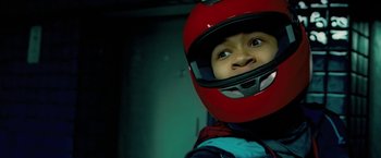 Movie still from “Attack the Block” (2011), directed by Joe Cornish – A young boy wearing a red motorcycle helmet; Close Up shot, Low angle