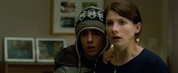 Movie still from “Attack the Block” (2011), directed by Joe Cornish – A man and a woman are posing for a picture; Close Up shot, Over the shoulder angle