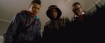 Movie still from “Attack the Block” (2011), directed by Joe Cornish – A group of young men standing next to each other in a room; Close Up shot, Low angle