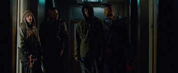 Movie still from “Attack the Block” (2011), directed by Joe Cornish – A group of men standing next to each other in the dark; Medium shot, Low angle