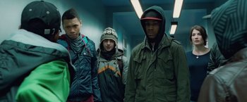 Movie still from “Attack the Block” (2011), directed by Joe Cornish – A group of young men standing next to each other; Medium shot, Low angle