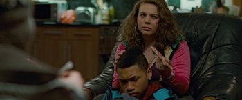 Movie still from “Attack the Block” (2011), directed by Joe Cornish – A young man getting his hair combed by a woman; Close Up shot, Over the shoulder angle