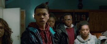 Movie still from “Attack the Block” (2011), directed by Joe Cornish – A group of young men standing next to each other; Close Up shot, Over the shoulder angle