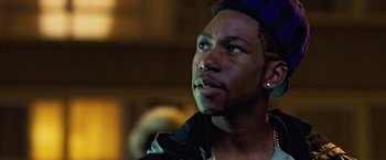 Movie still from “Attack the Block” (2011), directed by Joe Cornish – A person looking up at something; Close Up shot, Low angle