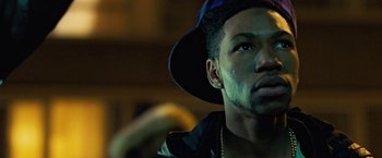 Movie still from “Attack the Block” (2011), directed by Joe Cornish – A person wearing a hat; Close Up shot, Low angle