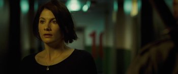 Movie still from “Attack the Block” (2011), directed by Joe Cornish – A woman in a black shirt is standing in a room; Close Up shot, Over the shoulder angle