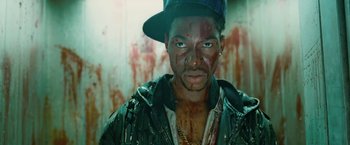 Movie still from “Attack the Block” (2011), directed by Joe Cornish – A person with blood on his face; Close Up shot, Low angle