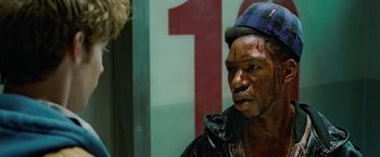 Movie still from “Attack the Block” (2011), directed by Joe Cornish – A man with blood all over his face; Close Up shot, Over the shoulder angle