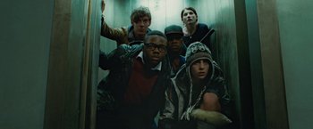 Movie still from “Attack the Block” (2011), directed by Joe Cornish – A group of young people standing in an elevator; Medium shot, Low angle