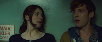 Movie still from “Attack the Block” (2011), directed by Joe Cornish – Two people standing next to each other near a wall; Close Up shot, Over the shoulder angle