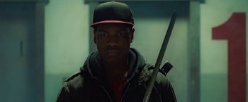 Movie still from “Attack the Block” (2011), directed by Joe Cornish – A man in a baseball cap holding a baseball bat; Close Up shot, Low angle
