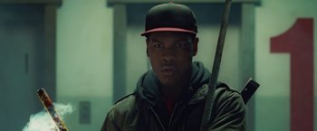 Movie still from “Attack the Block” (2011), directed by Joe Cornish – A man with a baseball cap holding a baseball bat; Close Up shot, Low angle