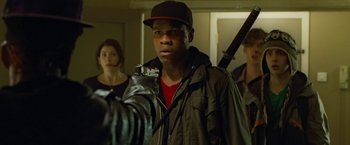 Movie still from “Attack the Block” (2011), directed by Joe Cornish – A young man holding a video camera in front of two other young people; Close Up shot, Over the shoulder angle