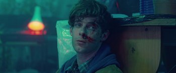 Movie still from “Attack the Block” (2011), directed by Joe Cornish – A young man with a bandage on his face; Close Up shot, Overhead angle