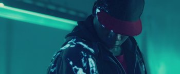 Movie still from “Attack the Block” (2011), directed by Joe Cornish – A man with a hat and a jacket on; Close Up shot, Low angle