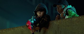 Movie still from “Attack the Block” (2011), directed by Joe Cornish – A young boy holding a toy gun while standing next to another young boy; Close Up shot, Low angle