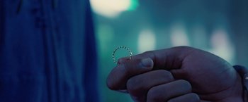 Movie still from “Attack the Block” (2011), directed by Joe Cornish – A person holding a ring in their hand; Extreme Close Up shot, Overhead angle