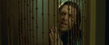 Movie still from “Attack the Block” (2011), directed by Joe Cornish – A man is looking through a wooden fence; Close Up shot, Low angle