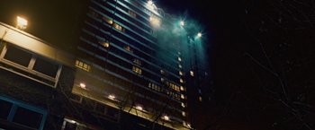 Movie still from “Attack the Block” (2011), directed by Joe Cornish – A building that is lit up at night time; Extreme Wide shot, Low angle