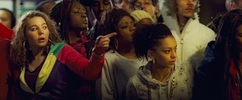 Movie still from “Attack the Block” (2011), directed by Joe Cornish – A group of people standing in a room; Medium shot, Over the shoulder angle
