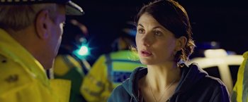 Movie still from “Attack the Block” (2011), directed by Joe Cornish – A person wearing a blue jacket; Close Up shot, Over the shoulder angle