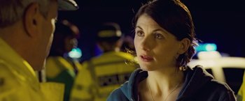 Movie still from “Attack the Block” (2011), directed by Joe Cornish – A person wearing a blue jacket; Close Up shot, Over the shoulder angle