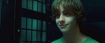Movie still from “Attack the Block” (2011), directed by Joe Cornish – A young man is smiling for the camera; Close Up shot, Low angle