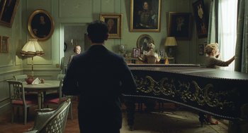 Movie still from “Attila Marcel” (2013), directed by Sylvain Chomet – A man is standing in front of a piano in a living room; Wide shot, Over the shoulder angle