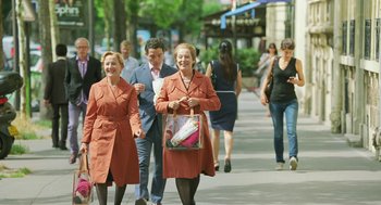 Movie still from “Attila Marcel” (2013), directed by Sylvain Chomet – A group of people walking down a sidewalk; Medium shot, High angle