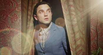 Movie still from “Attila Marcel” (2013), directed by Sylvain Chomet – A man in a blue suit looking up at the ceiling; Close Up shot, Low angle