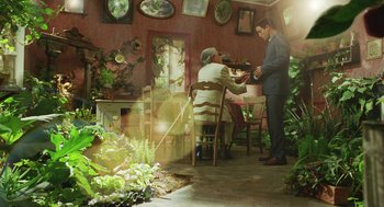 Movie still from “Attila Marcel” (2013), directed by Sylvain Chomet – A man standing next to an older man in front of a table; Wide shot, Low angle