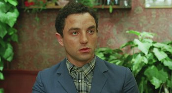 Movie still from “Attila Marcel” (2013), directed by Sylvain Chomet – A person wearing a suit and tie; Close Up shot, Over the shoulder angle
