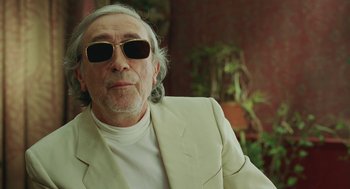 Movie still from “Attila Marcel” (2013), directed by Sylvain Chomet – An older man wearing sunglasses and a white jacket; Close Up shot, Low angle