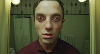 Movie still from “Attila Marcel” (2013), directed by Sylvain Chomet – A person wearing a red shirt; Close Up shot, Overhead angle
