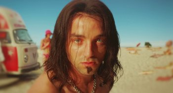 Movie still from “Attila Marcel” (2013), directed by Sylvain Chomet – A person with long hair on a beach; Close Up shot, Low angle