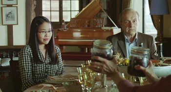 Movie still from “Attila Marcel” (2013), directed by Sylvain Chomet – Two people sitting at a table with a glass of wine; Medium shot, Over the shoulder angle