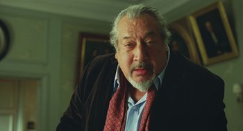 Movie still from “Attila Marcel” (2013), directed by Sylvain Chomet – An older man with a beard wearing a jacket and a tie; Close Up shot, Low angle