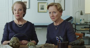 Movie still from “Attila Marcel” (2013), directed by Sylvain Chomet – Two older women sitting at a table in a room; Close Up shot, Over the shoulder angle