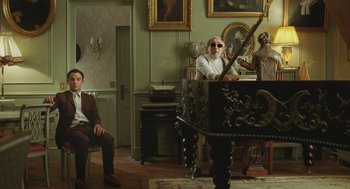 Movie still from “Attila Marcel” (2013), directed by Sylvain Chomet – Two men sitting in front of a piano in a living room; Wide shot, Low angle