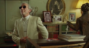 Movie still from “Attila Marcel” (2013), directed by Sylvain Chomet – An older man in a white suit sitting in front of a piano; Medium shot, Over the shoulder angle