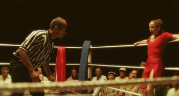 Movie still from “Attila Marcel” (2013), directed by Sylvain Chomet – A referee stands in the corner of a boxing ring as a crowd watches; Medium shot, High angle