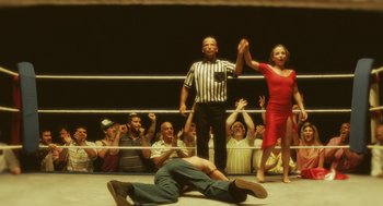 Movie still from “Attila Marcel” (2013), directed by Sylvain Chomet – A man and a woman wrestling in a ring; Wide shot, Low angle