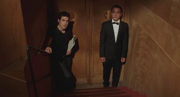 Movie still from “Attila Marcel” (2013), directed by Sylvain Chomet – Two young men in tuxedos standing in front of a door; Medium shot, Low angle