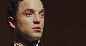 Movie still from “Attila Marcel” (2013), directed by Sylvain Chomet – A man's face with green eyes; Close Up shot, Low angle