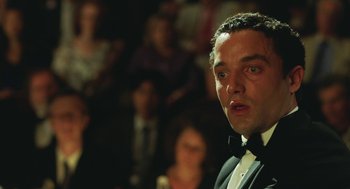Movie still from “Attila Marcel” (2013), directed by Sylvain Chomet – A person wearing a suit and a bow tie; Close Up shot, Low angle