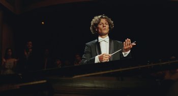 Movie still from “Attila Marcel” (2013), directed by Sylvain Chomet – A man in a tuxedo is holding a conductor's baton; Medium shot, Low angle